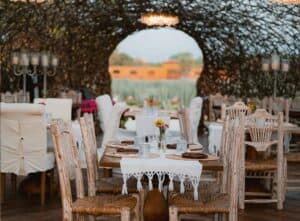 Set tables inside The Nest at Caracara, looking out through a round opening to the agave field