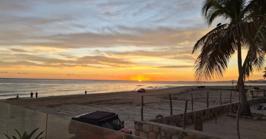 Sunrise over the Sea of Cortés from a palm-lined beach at Los Barriles