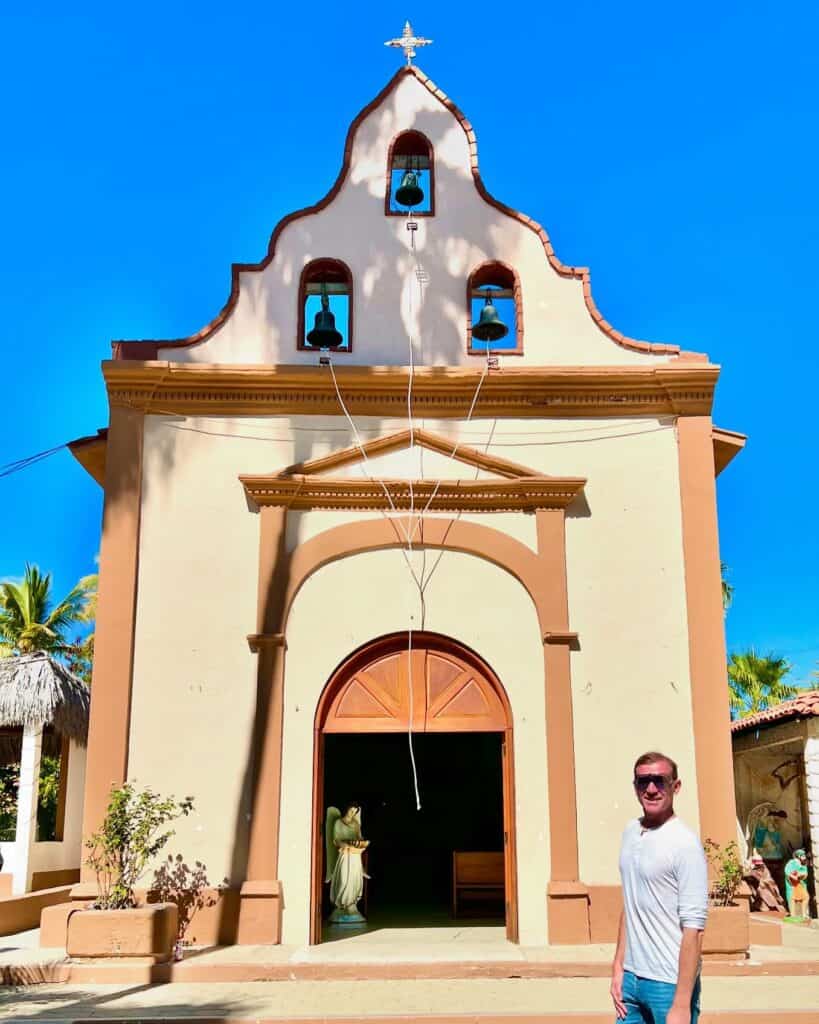 The yellow facade and bell towers of the church at Miraflores