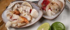 Chopped clam and tomato served in the shell with lime halves at Mariscos El Toro Güero