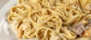 Seafood fettuccine in a cream sauce topped with grated cheese at Mariscos El Toro Güero
