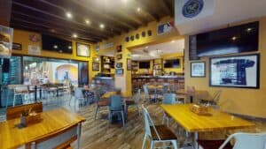 Tables in the Golden Legends dining room, with framed jerseys and league banners on the walls and the bar at the back