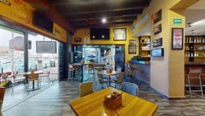 The Golden Legends dining room opening onto the marina, with sports memorabilia on the yellow walls