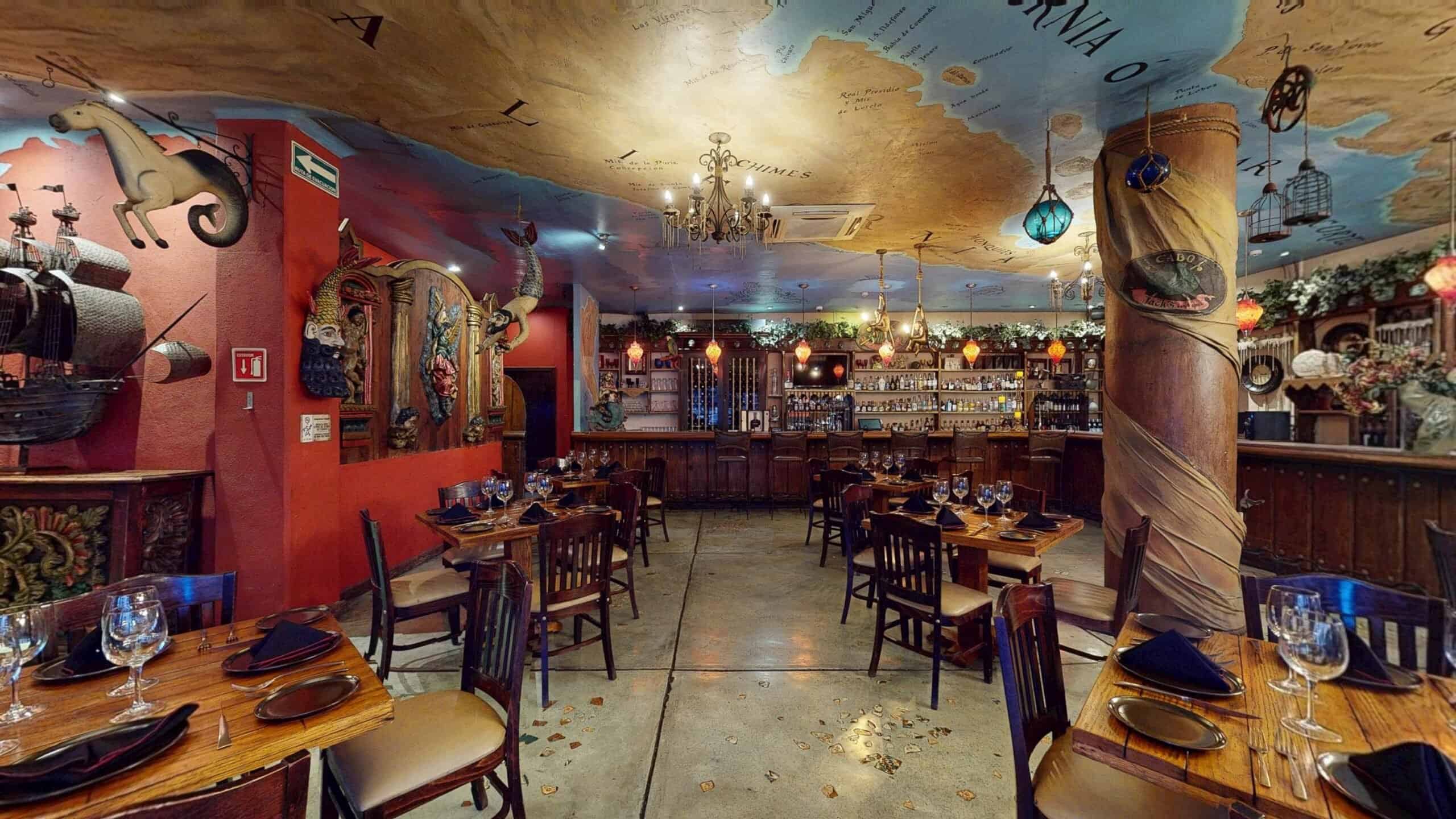 The main dining room at Jack's Steak House, with a painted sea-chart ceiling, a model galleon and the bar at the back