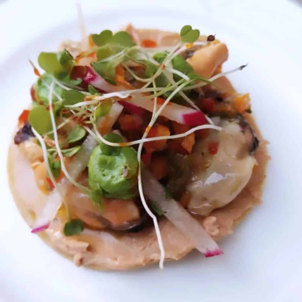 A plated dish with microgreens at NIM restaurant in La Paz