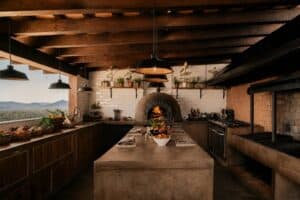 The open kitchen at Monte Cardón, with its wood-fired dome oven, concrete island and a window onto the desert mountains