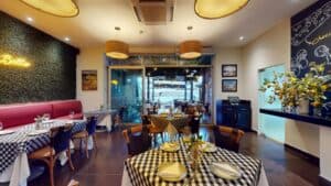 Presto's indoor dining room looking out through glass doors to the terrace on the marina