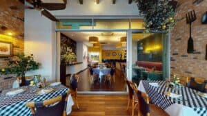 Tables on the brick-walled terrace at Presto in front of the glass doors to the indoor dining room