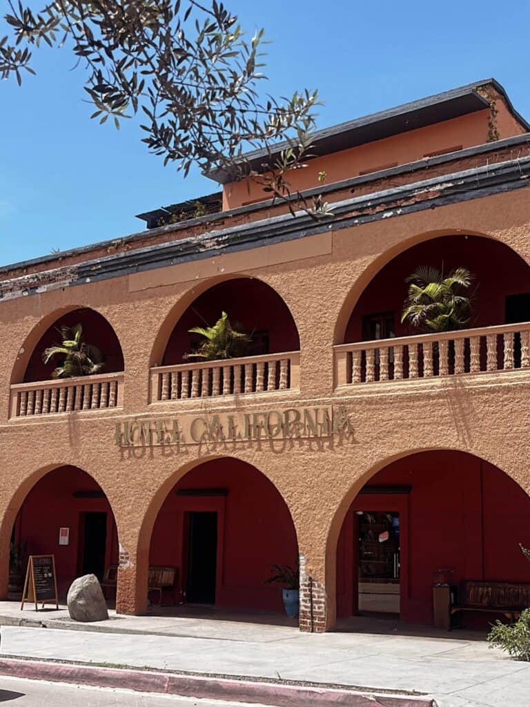 The orange arcades and sign of Hotel California in Todos Santos