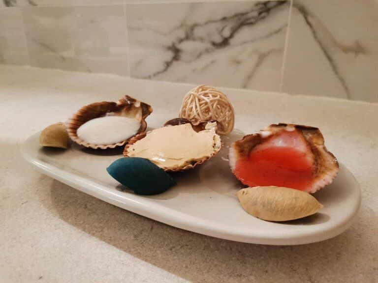 Treatment products served in seashells on a dish at Amura Spa
