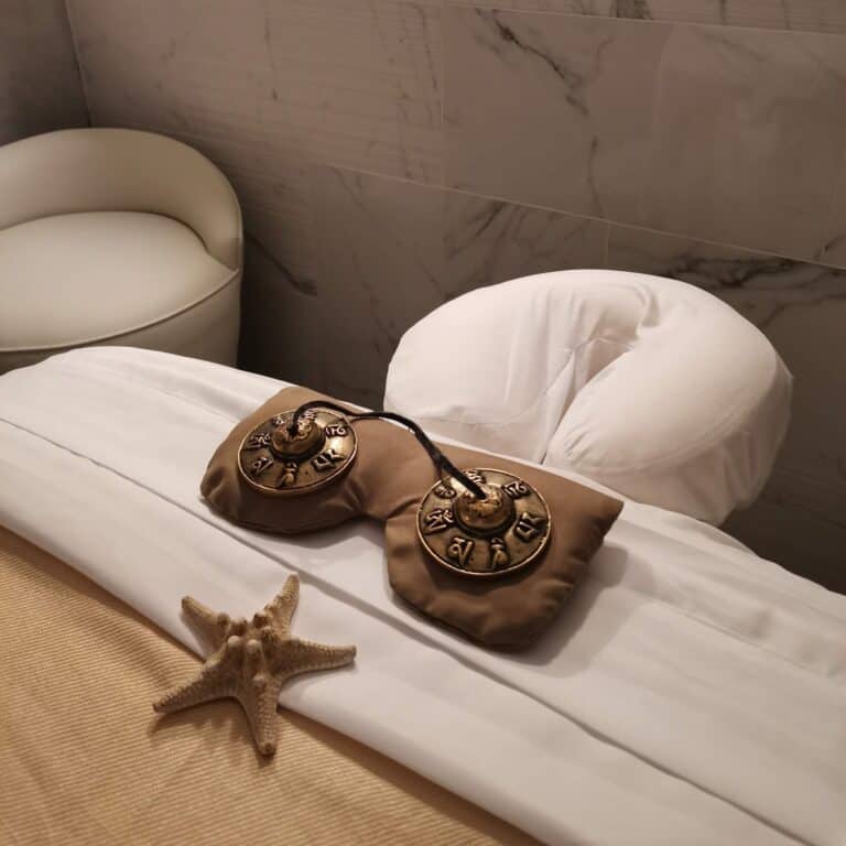 Tingsha cymbals and a starfish on a massage table at Amura Spa