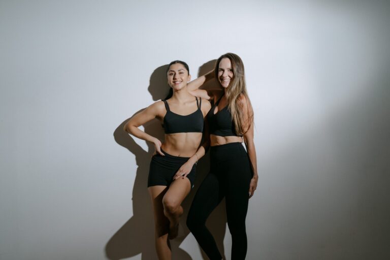 Founder Erin Crookbain and instructor Liza Lomelí smiling in the Cabo Yoga and Fitness studio