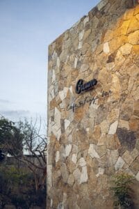 The stone wall with the Cream sign at the entrance to its Ánima Village location in Cabo del Sol