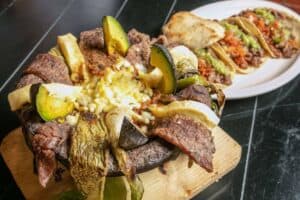 Molcajete with grilled meats, nopales, avocado and cheese at Las Guacamayas