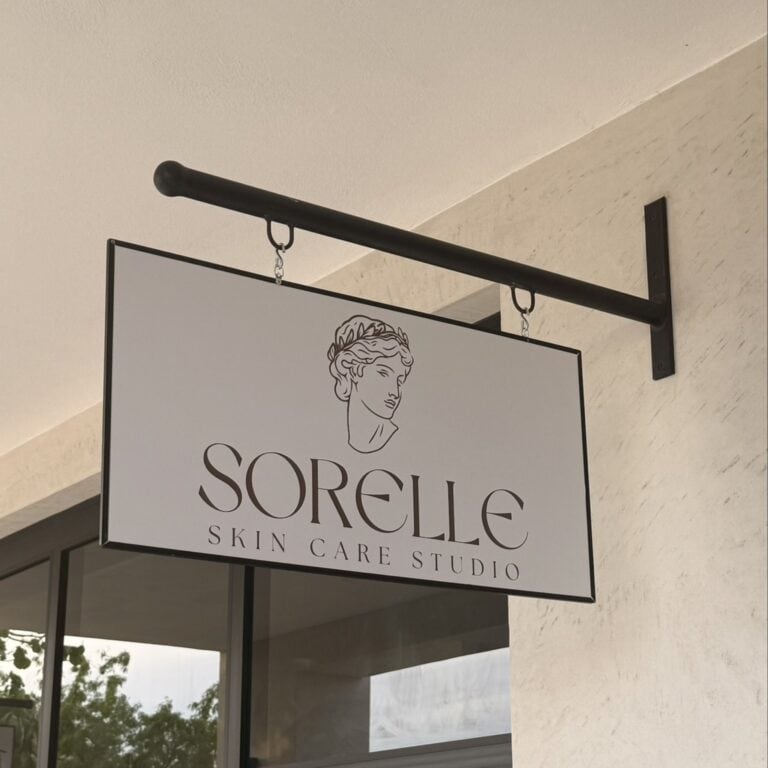 Hanging Sorelle Skin Care Studio sign at the studio entrance in Plaza El Naranjo