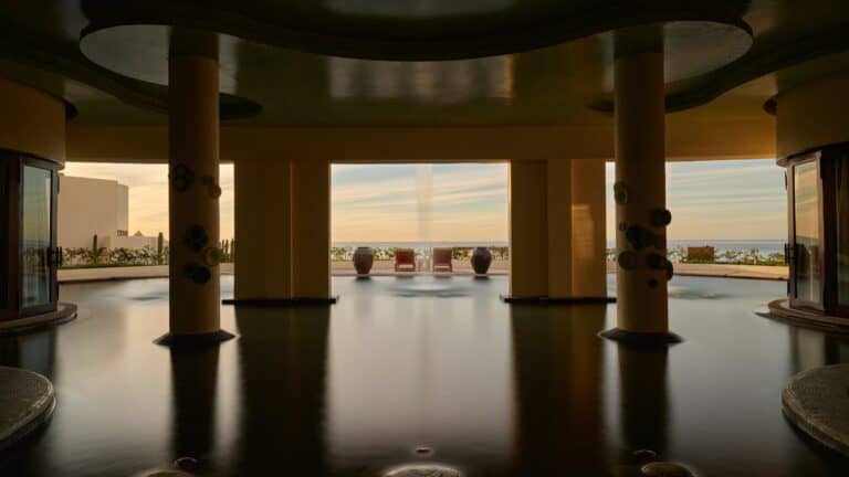 Columns rising from the spa pool, with an ocean view at sunset, at Waldorf Astoria Spa